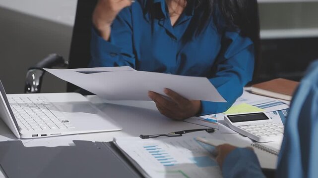 Asian male financial officer or accountant checking investment results Financial budget analysis Planning to summarize results and report to the meeting Audit concept and investment results.