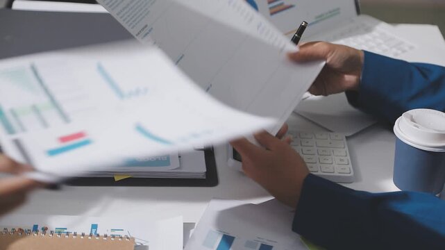 Asian male financial officer or accountant checking investment results Financial budget analysis Planning to summarize results and report to the meeting Audit concept and investment results.