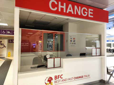 Rome, Italy - January 14, 2026: Currency exchange counter labeled CHANGE in an airport, featuring a glass partition and signage for BFC Best and Fast Change Italia