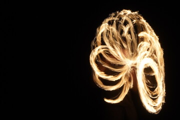 Fire Poi Performance on Beach at Night.