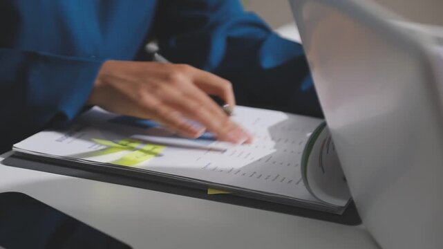 Asian male financial officer or accountant checking investment results Financial budget analysis Planning to summarize results and report to the meeting Audit concept and investment results.