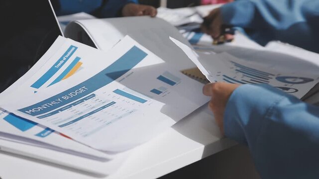 Asian male financial officer or accountant checking investment results Financial budget analysis Planning to summarize results and report to the meeting Audit concept and investment results.