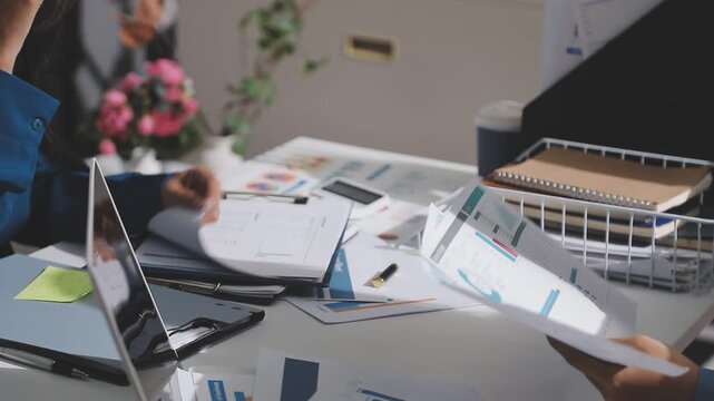 Asian male financial officer or accountant checking investment results Financial budget analysis Planning to summarize results and report to the meeting Audit concept and investment results.