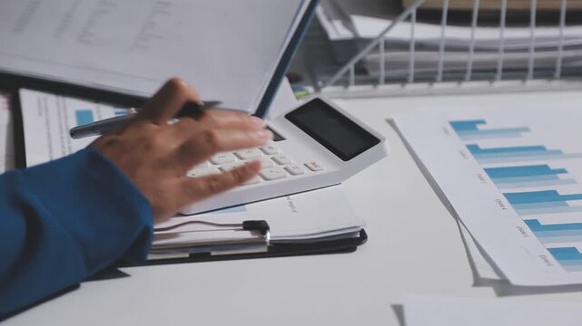 Asian male financial officer or accountant checking investment results Financial budget analysis Planning to summarize results and report to the meeting Audit concept and investment results.