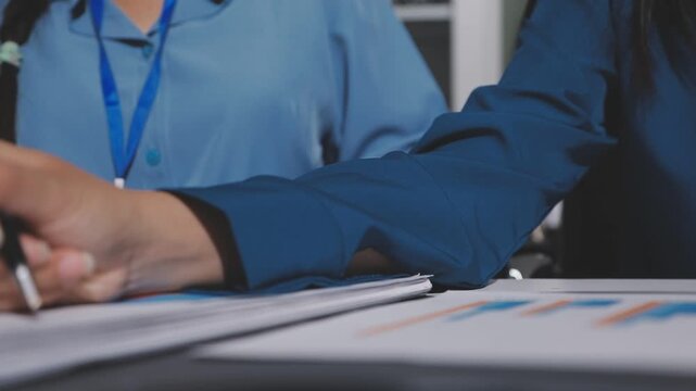 Asian male financial officer or accountant checking investment results Financial budget analysis Planning to summarize results and report to the meeting Audit concept and investment results.