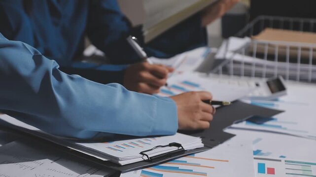 Asian male financial officer or accountant checking investment results Financial budget analysis Planning to summarize results and report to the meeting Audit concept and investment results.