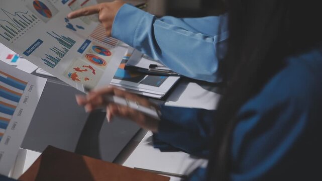 Asian male financial officer or accountant checking investment results Financial budget analysis Planning to summarize results and report to the meeting Audit concept and investment results.