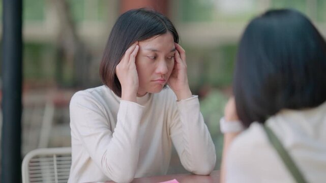 Emotional dispute among young adult students regarding responsibility for errors in thesis paper causing anger and frustration while meeting outside university building on a sunny afternoon day