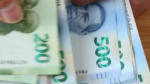Mexico money. Counting a larger amount of cash. Mexican pesos, businessman's hands. Close up. Financial concept