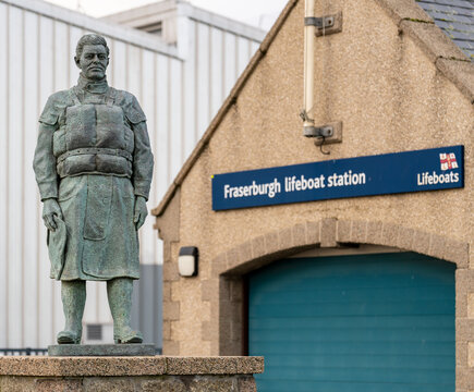 Life-sized bronze statue of rnli crewman stands outside fraserburgh lifeboat station in Scotland