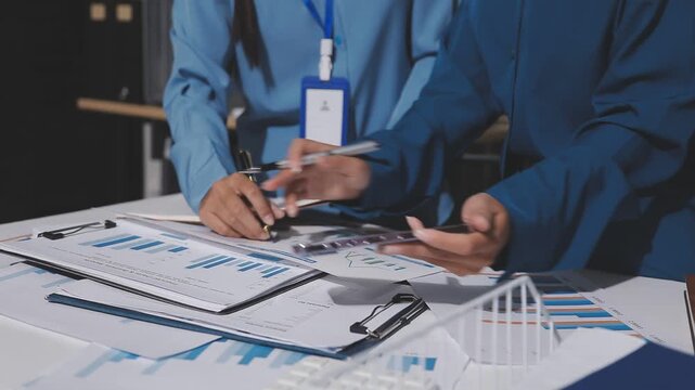 Asian male financial officer or accountant checking investment results Financial budget analysis Planning to summarize results and report to the meeting Audit concept and investment results.