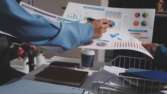Asian male financial officer or accountant checking investment results Financial budget analysis Planning to summarize results and report to the meeting Audit concept and investment results.