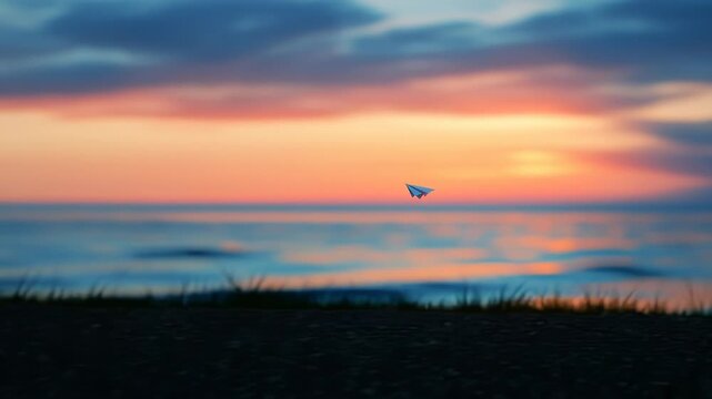A paper airplane gracefully floats above a serene sunset ocean. Vibrant sky colors reflect beautifully on the calm water below.