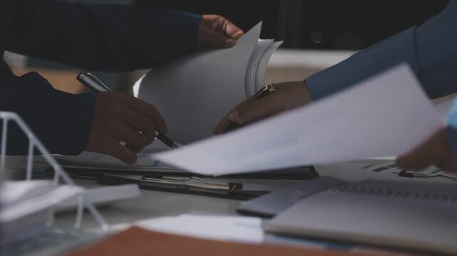 Asian male financial officer or accountant checking investment results Financial budget analysis Planning to summarize results and report to the meeting Audit concept and investment results.