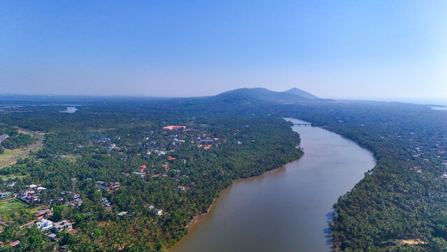 Scenic landscape view of Ezhimala hills situated in Kannur district, Kerala. The image captures the majestic seven hills overlooking the Arabian Sea, surrounded by lush greenery and rocky terrain.