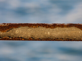 A rusty metal pole with a crack in it