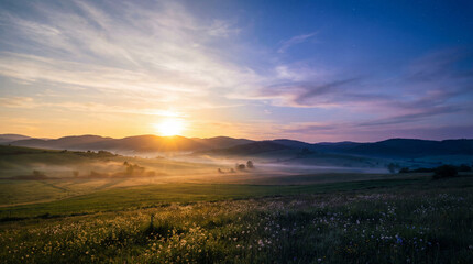 Obraz premium Misty sunrise over rolling green hills. Sunrise rays glow in fog, sunrise colors wash meadow for Earth Day campaign, summer travel promo, mindfulness wellness background with copy space