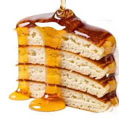 A stack of layered pancakes being drizzled with honey from above, showcasing the sweet treat in a close-up view