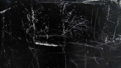 Dark black dirty texture with scratches, dust, and noise. Grunge abstract background with white scratch details. Black distressed overlay background for design.