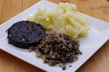 Plate of mashed potato, black pudding and haggis