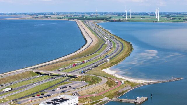 cluster dark modern visitor buildings integrated into landscape historic grassy bunkers winding footpaths sit major highway afsluitdijk netherlands near architecture 