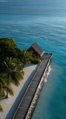 Fototapeta premium Aerial View of a Resort Pier Extending Over the Calm Tropical Ocean Waters