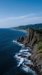 Dramatic Cliffside Island Rising Vertically from the Sea under Clear Blue Sky