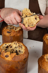 Confectioner patiently removing the top of the panettone_vertical.