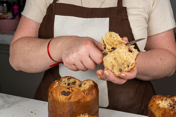 Confectioner patiently removing the top of the panettone.