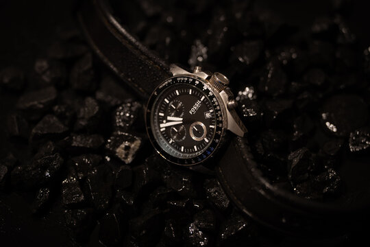 Bucharest Romania 18 January 2026.Stylish Fossil men&rsquo;s wristwatch displayed on a textured background of black stones. Elegant timepiece product photo highlighting luxury.