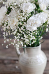 Naklejka premium White carnations and gypsophila paniculata in one arrangement. Bridal floristry.