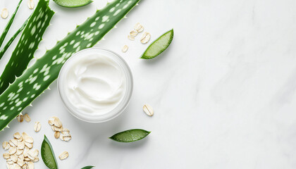 White jar of cream rests among green leaves and small particles on a clean white surface. Natural ingredients and skin care product