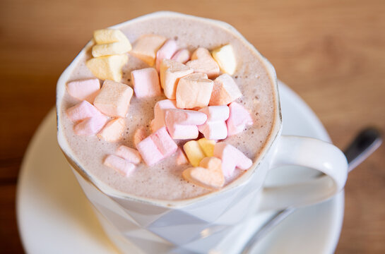 Hot cocoa with heart-shaped marshmallows in a white cup. Close up photo