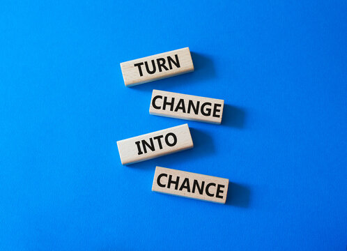 Change and Chance symbol. Concept words Turn Change Into Chance on wooden blocks. Beautiful bright blue background. Business and Turn Change Into Chance concept. Copy space.