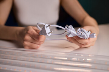 Hands connecting cable, Cable connection during hydroponic system maintenance, Closeup of...