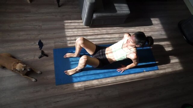 Woman doing hip thrust exercise at home