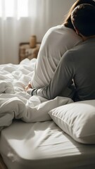 Couple embracing intimately on bed with soft morning light