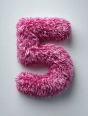 Number five made of pink fluffy material on a light background for decoration or crafts