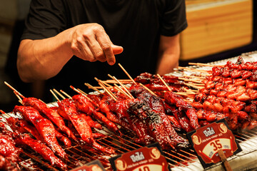 Motion blur of a busy chef at work. The energetic atmosphere of Thai night