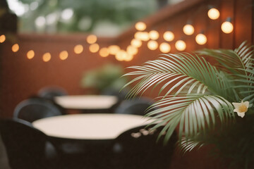 Fototapeta premium Cozy outdoor patio seating area with string lights and tropical palm leaves