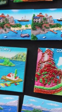 View of traditional tourist souvenirs and gifts from Kerkyra, Corfu island, Ionian sea, Greece, fridge magnets with text "Corfu","Greece" and key ring keychain, in local vendor souvenir shop kiosk
