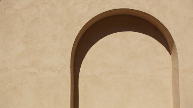 Minimalist Archway Shadow on Textured Beige Stucco Wall Background