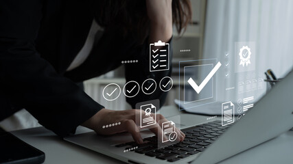 A professional engaged in work on a laptop, surrounded by a digital interface of checklists and...