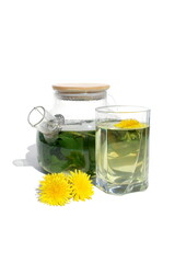 On a white background there is a teapot with a decoction of dandelion leaves.	