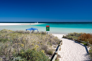 Stunning Coral Bay oceanfront white sandy beach turquoise waters pristine reef accessible from shore tropical Australian beach destination © jovannig