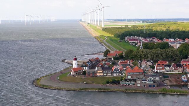 white lighthouse red stands sentinel grassy tip line offshore wind turbines stretches into distance acoastline urk netherlands long top coastline iconic structure nautical navigation 