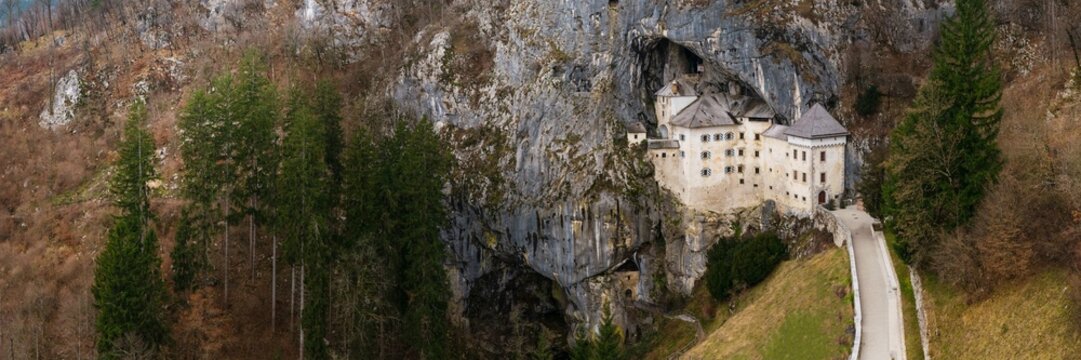 Epic Aerial Panorama of Predjama Castle: Medieval Renaissance Fortress Built into a Cave Mouth, Slovenia Landmark, No People