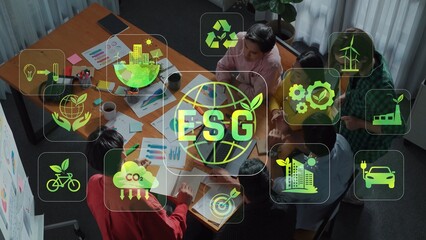 A diverse team engages in a strategic discussion about ESG initiatives, utilizing data visualizations and collaborative efforts to drive sustainable corporate practices. Raster