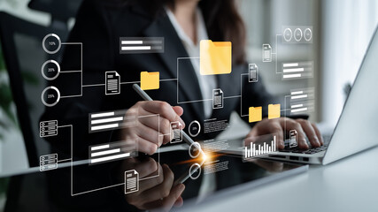 A business professional reviews digital data visualizations and documents on a laptop in a modern office, emphasizing innovative data analysis and strategic insights. Gantry