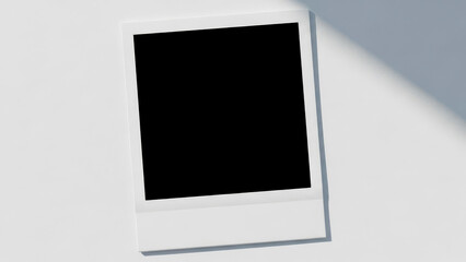 Blank instant photo frame on a white background with subtle shadows